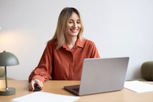 Mujer rubia sentada con el ordenador